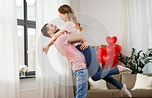 Happy couple at home on valentines day photo