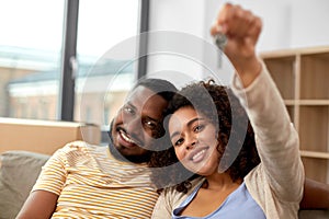 Happy couple with house key moving to new home