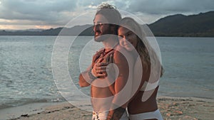 Happy couple, hug and beach for love, embrace or care on holiday vacation, weekend or tropical getaway. Woman hugging