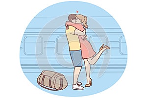 Happy couple hug meeting at railway station