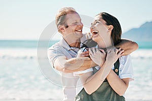 Happy, couple and hug by the sea with love, laughing and bonding on vacation at ocean. Summer, romance and people