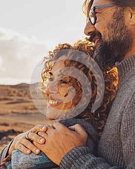 Happy couple hugging and enjoying travel destination. together with smile and serene expression. One man embrace woman from behind