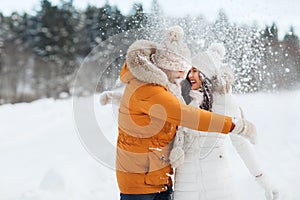 Happy couple hugging and laughing in winter