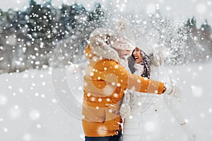 Happy couple hugging and laughing in winter