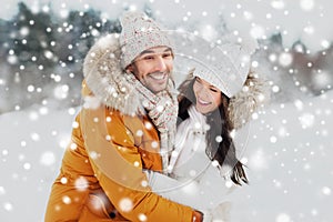 Happy couple hugging and laughing in winter