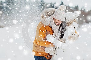 Happy couple hugging and laughing in winter