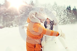 Happy couple hugging and laughing in winter