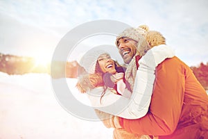 Happy couple hugging outdoors in winter