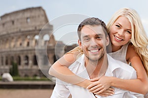 Happy couple hugging over coliseum