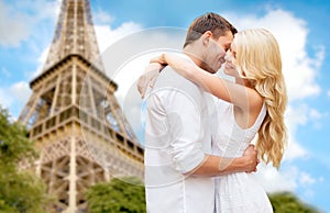 Happy couple hugging over eiffel tower