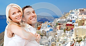 Happy couple hugging over santorini island