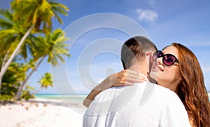 Happy couple hugging over tropical beach