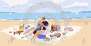 Happy couple hugging on picnic blanket at seaside. Young man and woman spending time together with wine and food at