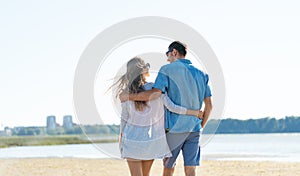 Happy couple hugging on summer beach