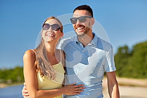 Happy couple hugging on summer beach