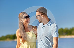 Happy couple hugging on summer beach