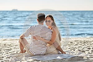 happy couple hugging on summer beach