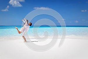 Happy couple hugging on a tropical beach