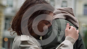 Happy couple hugging on urban street. Man and woman enjoying romantic date.