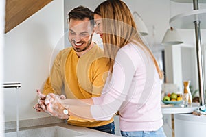 Happy couple, husban, wife are washing their hand. Protection against infection and virus