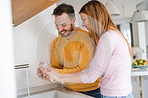 Happy couple, husban, wife are washing their hand. Protection against infection and virus