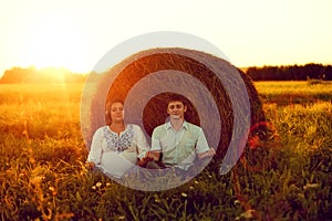 Happy couple husband and wife meditate on the nature near the ha