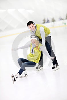 Happy couple in the ice rink