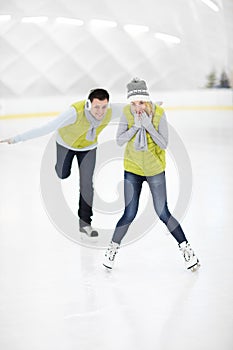 Happy couple in the ice rink