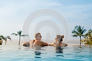 Happy couple in infinity pool