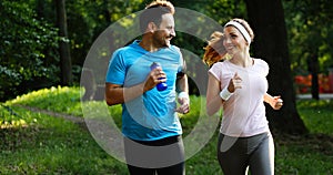 Happy couple jogging and running outdoors in nature