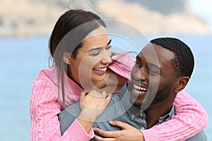 Happy couple joking and laughing on the beach photo