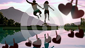 Happy couple jumping in a lake and hearts for valentine day