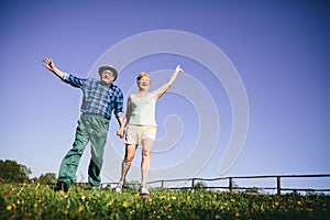 Happy couple jumping and waving.