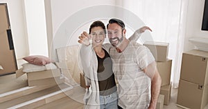 Happy couple, keys to new house and boxes for moving success, mortgage or property investment with hug. Excited portrait