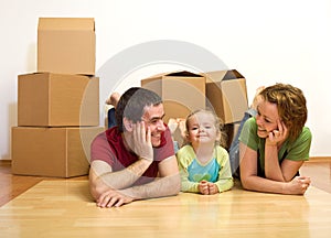 Happy couple with a kid in their new home