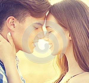 Happy couple kissing and hugging outdoors