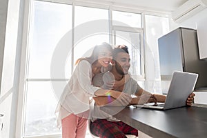 Happy Couple On Kitchen Using Laptop Computer Modern Apartment With Panoramic Window