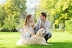 Happy couple with labrador dog walking in city