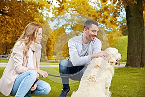 Happy couple with labrador dog walking in city