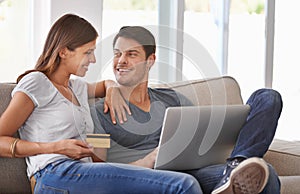 Happy couple, laptop and sofa with credit card for online shopping, payment or purchase in living room at home. Man and