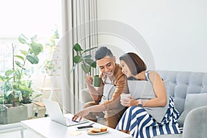 Happy couple with laptop spending time together at home