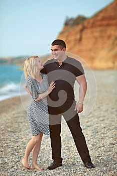 Happy couple laughing on the beach. outdoor portrait.