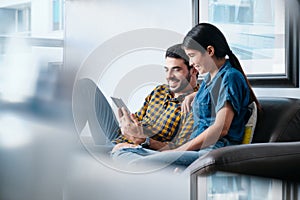 Happy Couple Laughing While Watching Video On Tablet