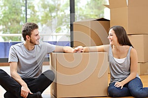 Happy couple looking at each other moving home