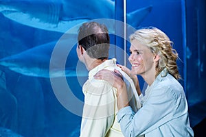 Happy couple looking at fish tank