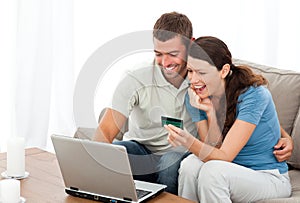 Happy couple looking at their accounts online