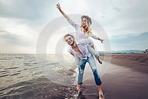 Happy couple in love on beach summer vacations.