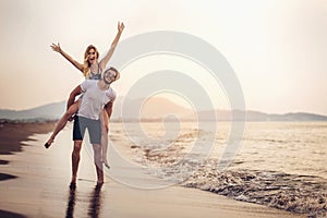 Happy couple in love on beach summer vacations.