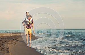 Happy couple in love on beach summer vacations.