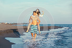 Happy couple in love on beach summer vacations.